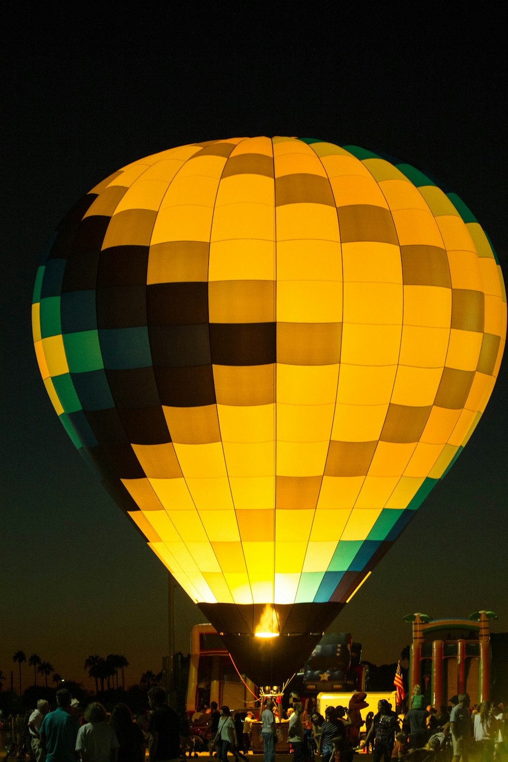 group of people in front of multicolored hot air balloon