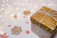Close-up of a luxurious gold-accented gift box with a satin ribbon.