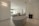 white ceramic bathtub near black textile