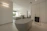 Elegant bathroom corner with soft lighting and minimalist decor featuring premium textiles.