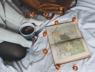 A traveler checking documents and a map, planning a journey with a cup of tea nearby.