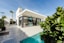white and grey concrete building near swimming pool under clear sky during daytime