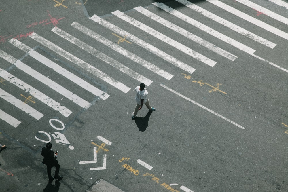 two man walking on pedestrian lane during daytime