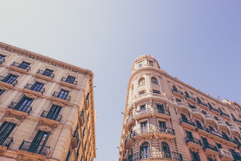 worm's eyeview photo of beige high-rise buildings