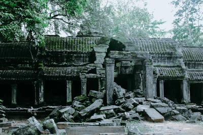 Collapsed stone corridor with rubble piled amid Ta Prohm's ruins (via Unsplash)