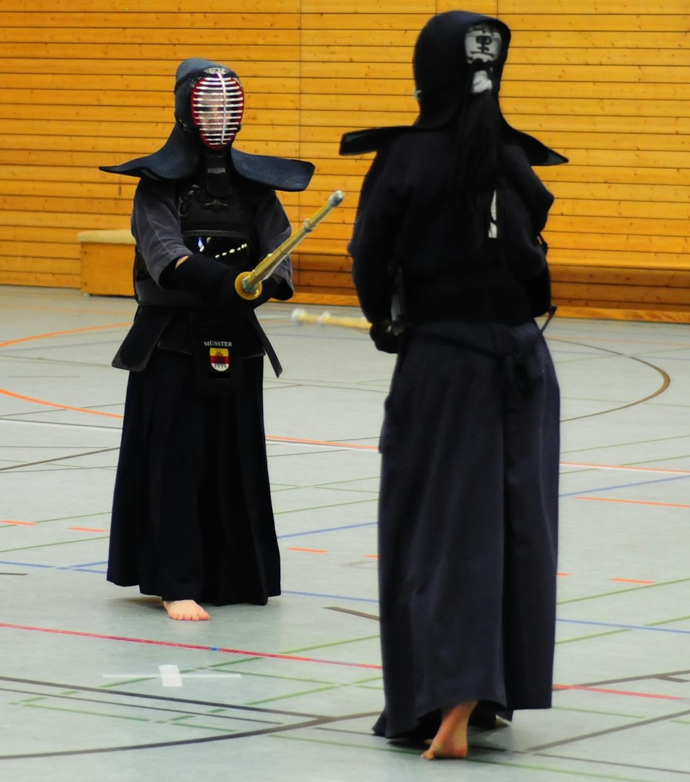 a couple of people that are standing in a court