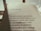 The image features an open book with a page of Portuguese text. The title reads 'Esses poetas,' followed by several poetic lines. The lighting is warm and casts a soft shadow on the page, suggesting early morning or late afternoon sunlight.