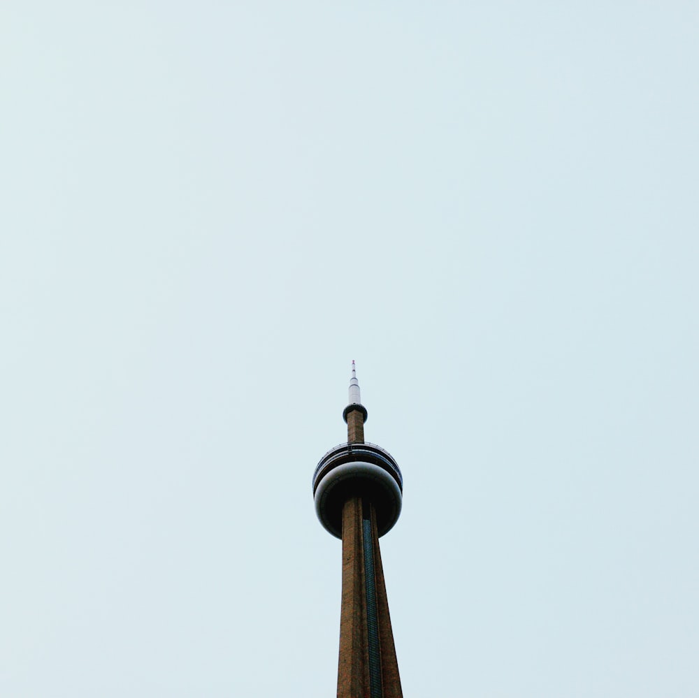 low angle photography of CN tower under blue sky during daytime