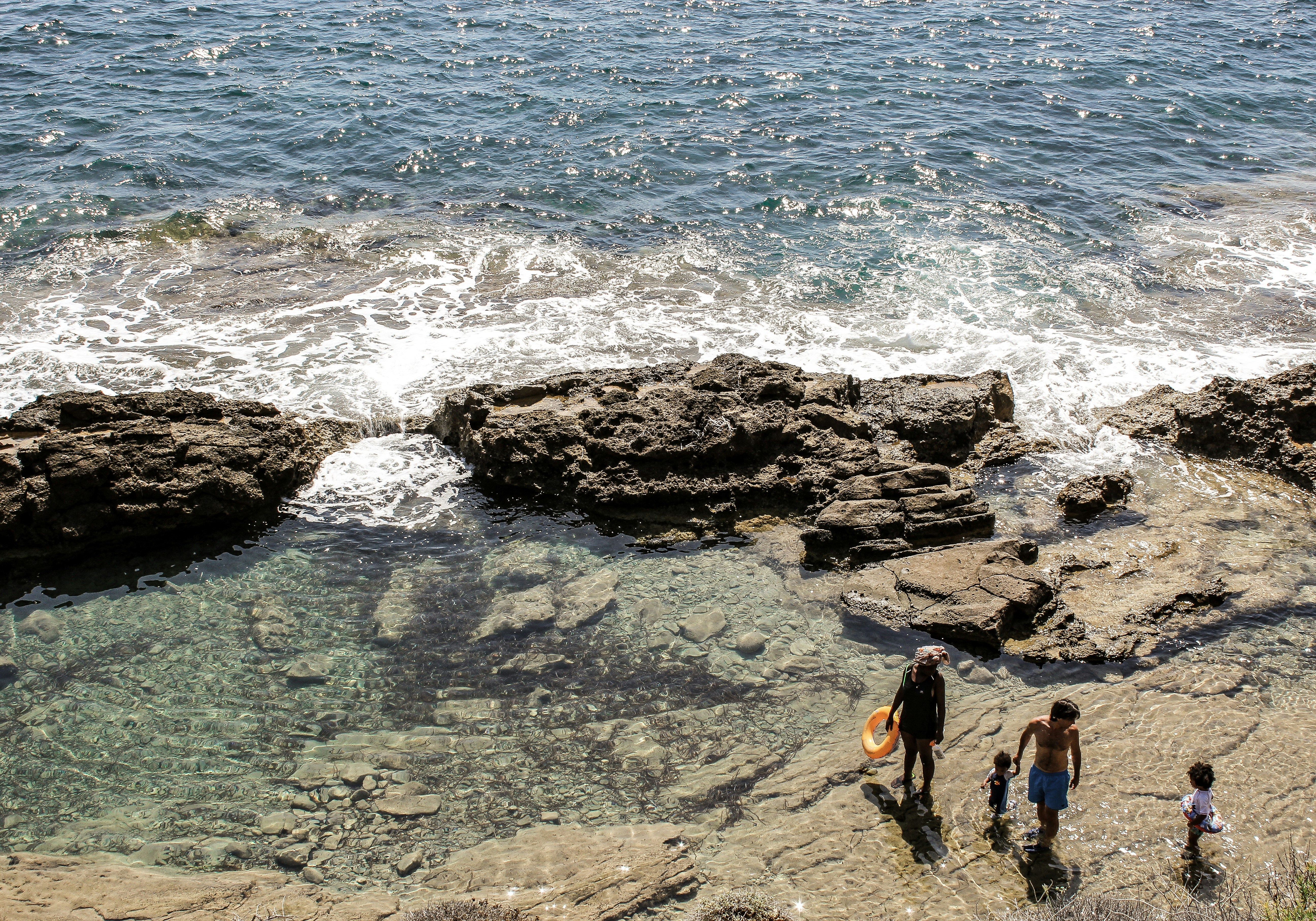 What’s the most important thing in life? Family. After a nice hike along the Spanish coast, walking up the steep cliffs I came across a very remote and deserted part of the beach. Only big rocks and stones breaking waves! But right in the middle of all the madness I saw this family, walking and laughing together. Made for the perfect holiday picture.