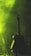 An acoustic guitar is silhouetted against a backdrop of green light and smoke, creating a moody atmosphere.