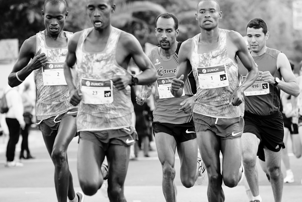 a group of men running down a street