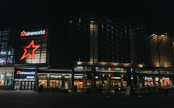 Security guards patrolling a busy commercial complex at night with golden lighting.