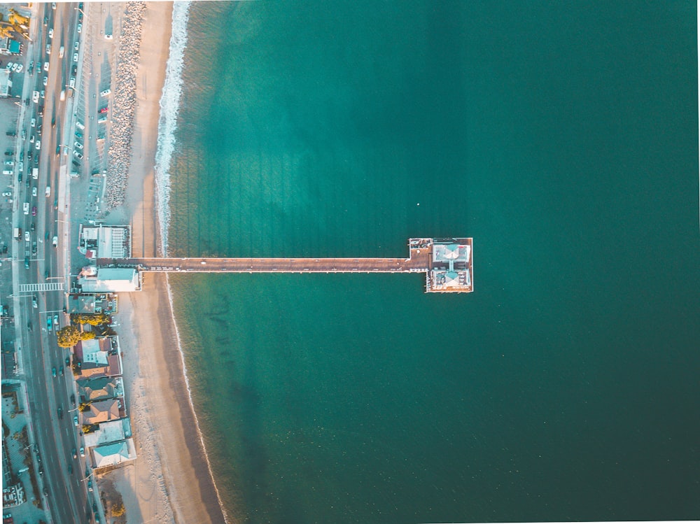 aerial view photography of green sea near dock at daytime