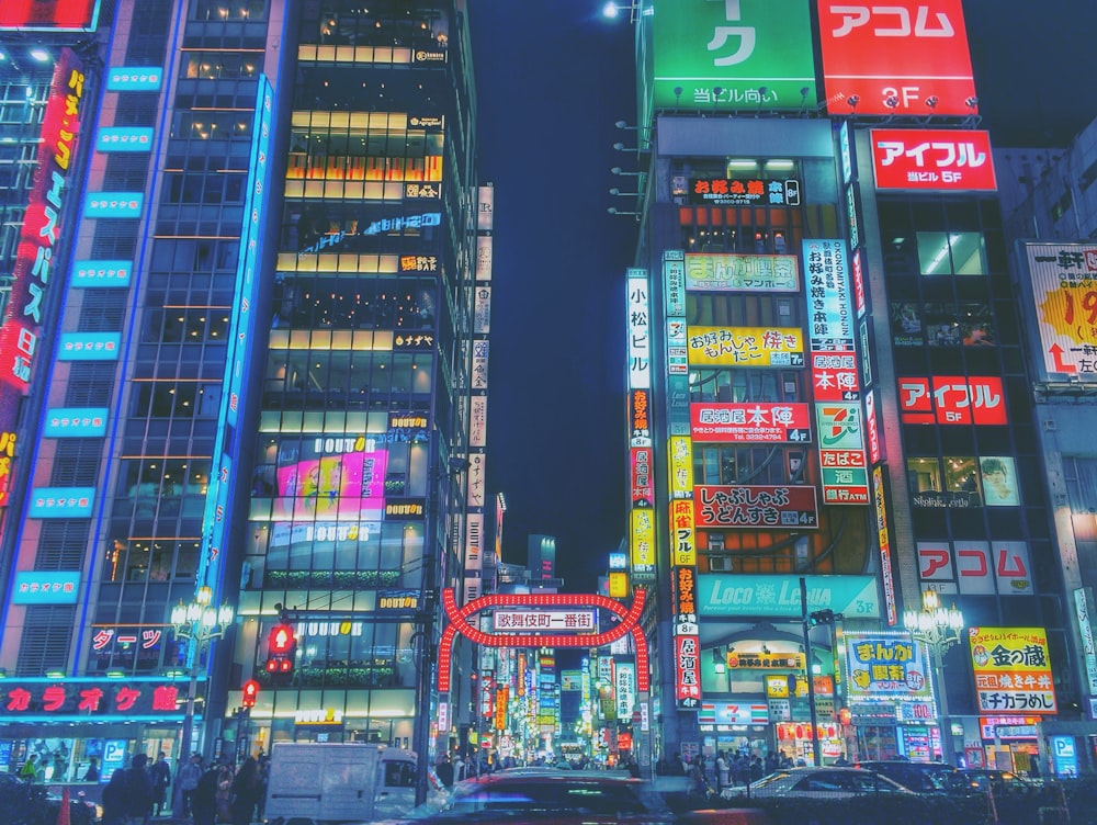 a busy city street at night with neon lights