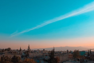 A serene cloud transforming into a glowing blueprint over a cityscape.