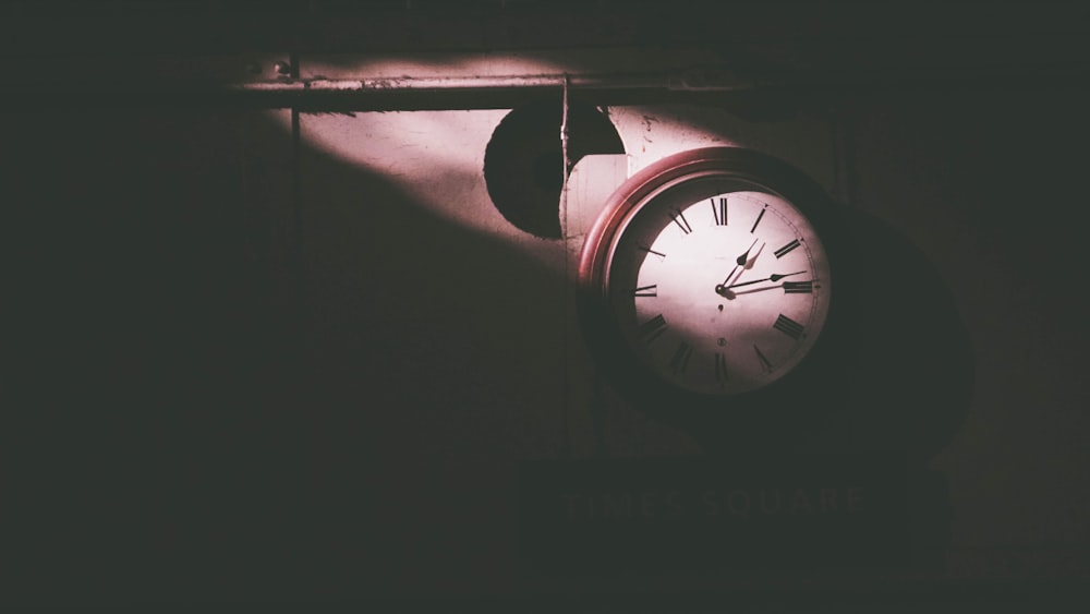 round white and brown wall clock