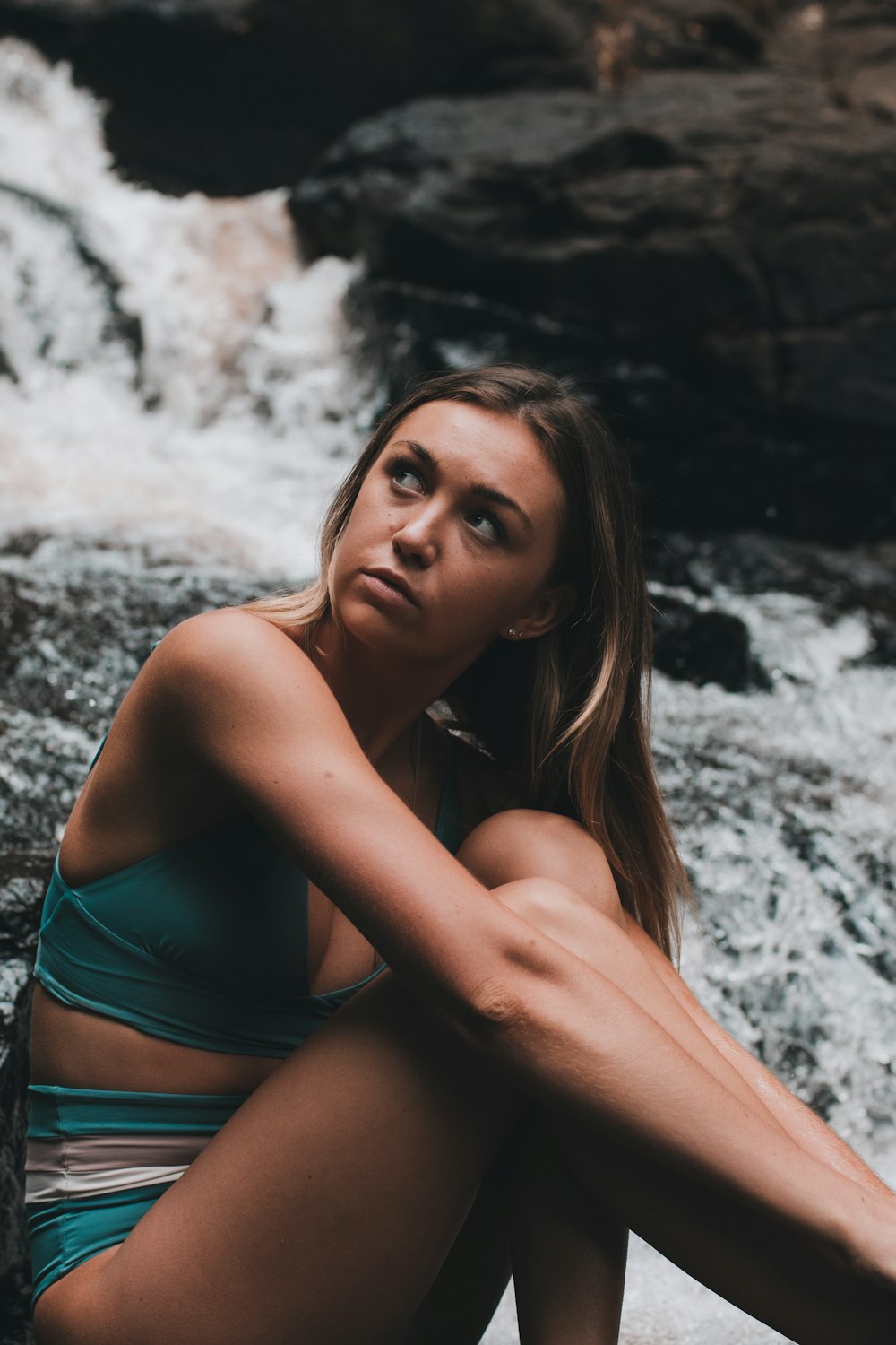 woman sitting on rock formation