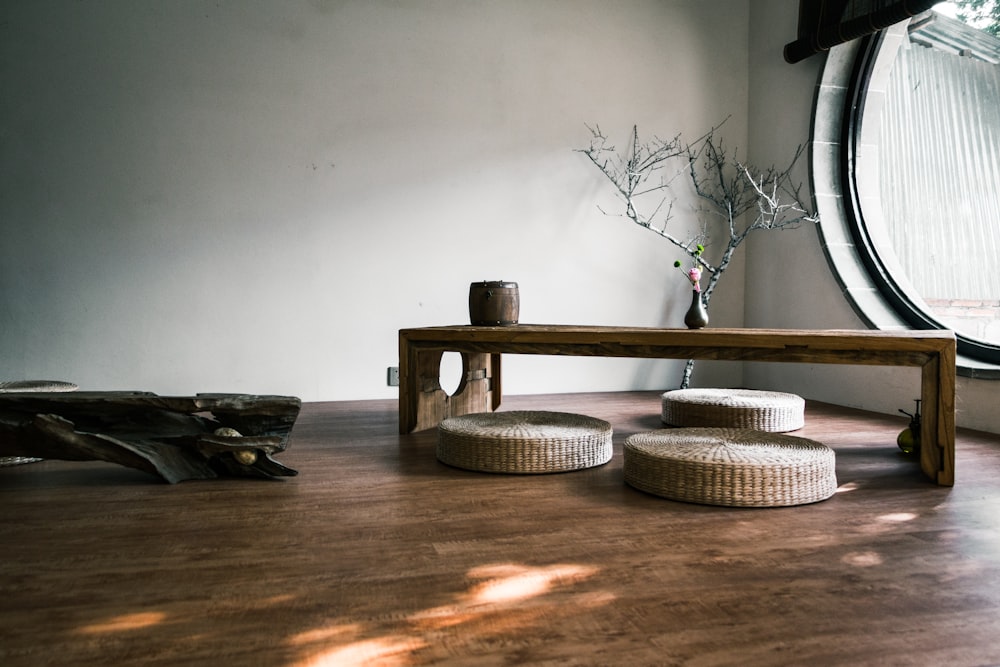 brown wooden bench near window