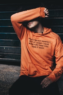 man sitting on gray stone