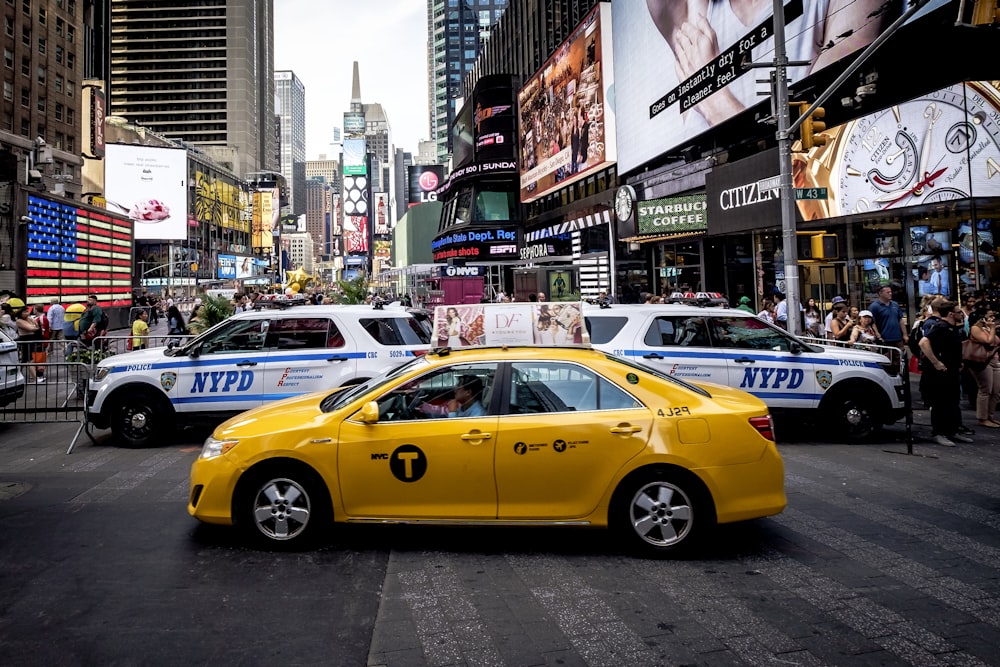 yellow sedan beside police cars