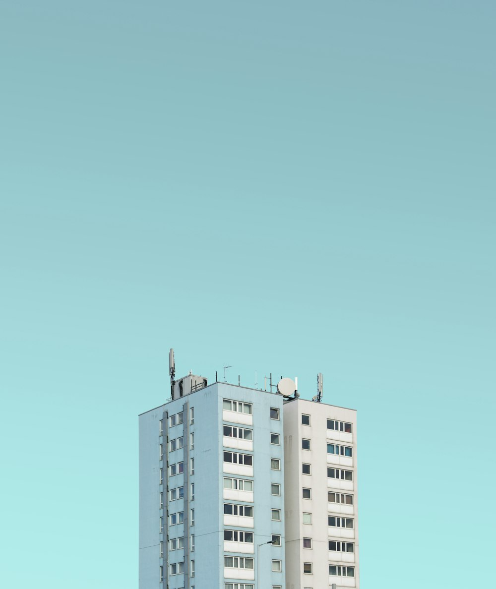 white painted high-rise building under clear sky