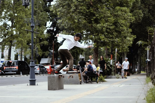 man skateboarding beside street during daytime in Bandung Indonesia
