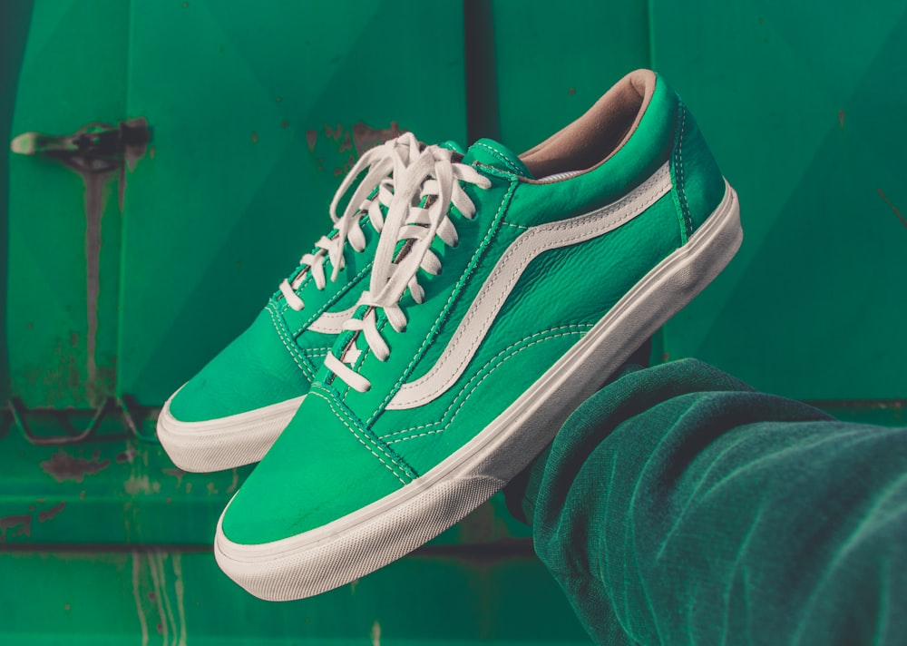 person holding pair of green Vans shoes photo – Green Image on Unsplash