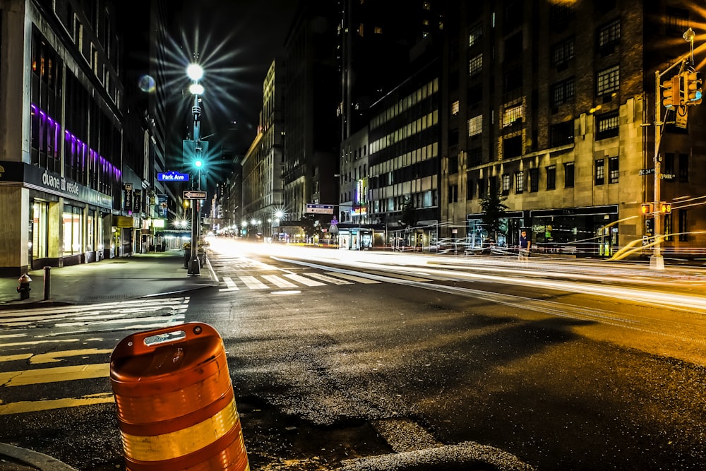 timelapse photography of asphalt road surrounded by commercial buildings during nighttime