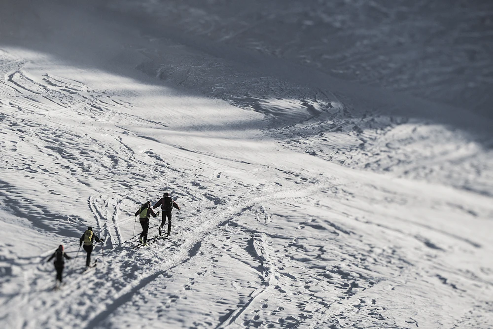 Hikers crossing a snowy mountain pass