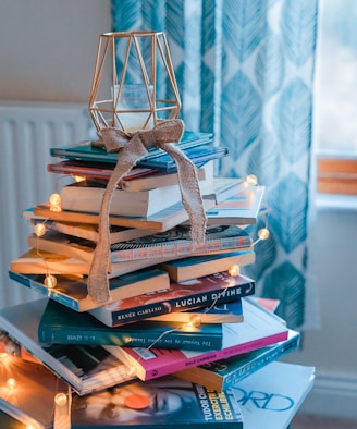 brown wooden framed candle holder on top of books