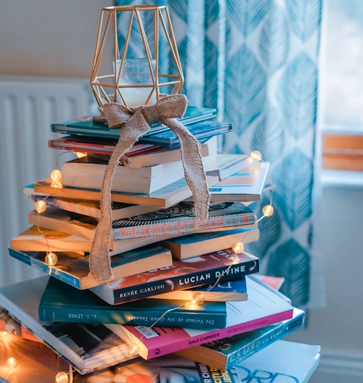 brown wooden framed candle holder on top of books