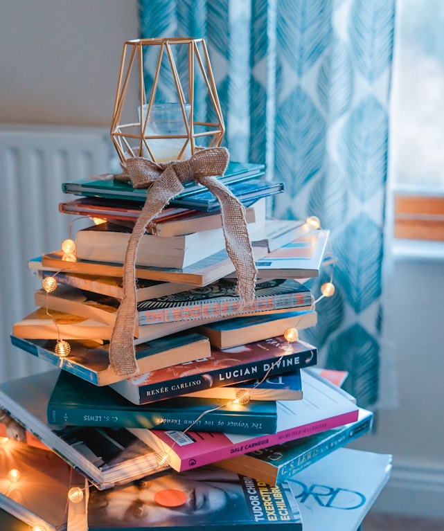brown wooden framed candle holder on top of books
