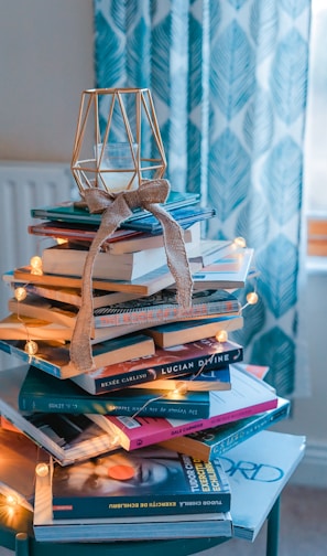 brown wooden framed candle holder on top of books