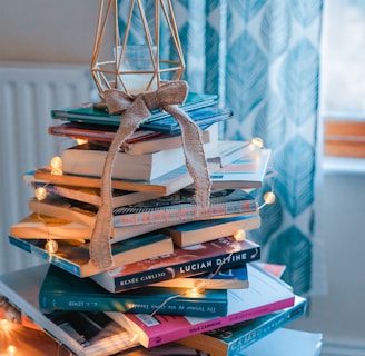 brown wooden framed candle holder on top of books