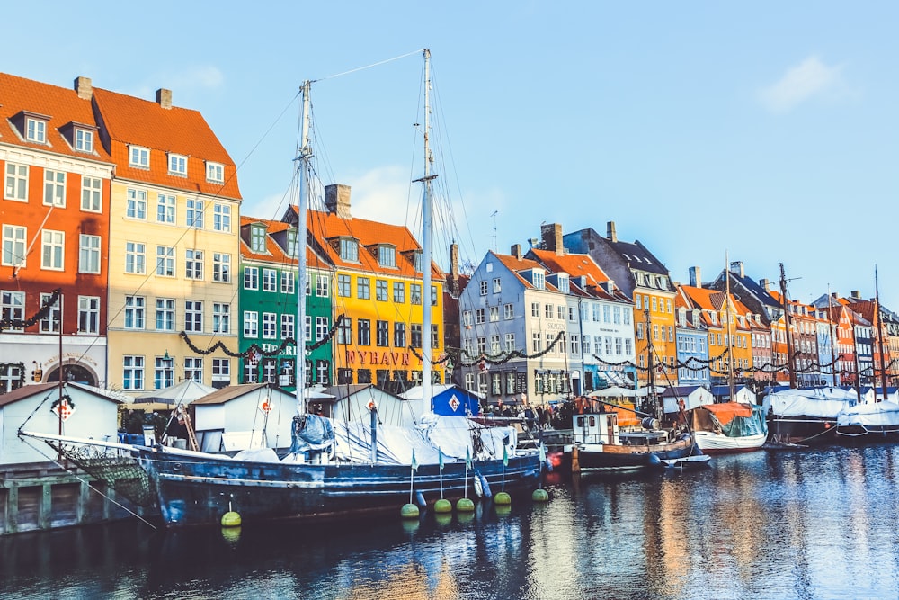 blue and white boat near buildings at daytime