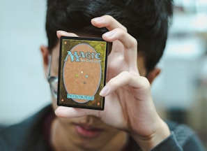 boy holding Magic: The Gathering trading card