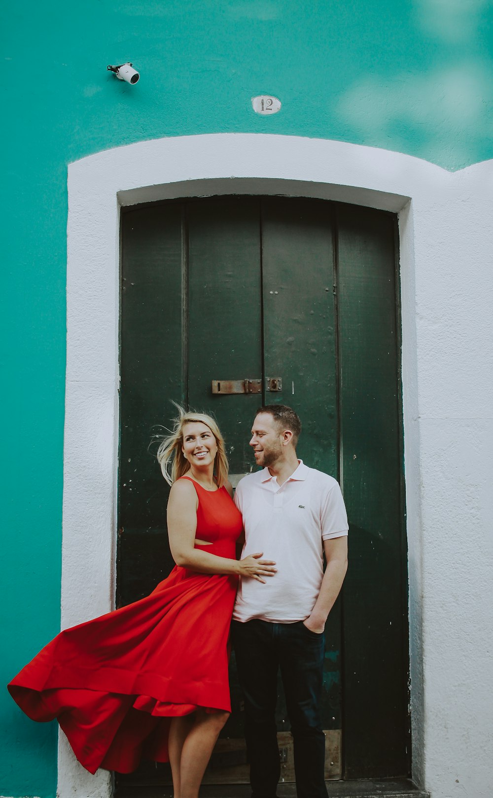 man and woman standing near door during daytime