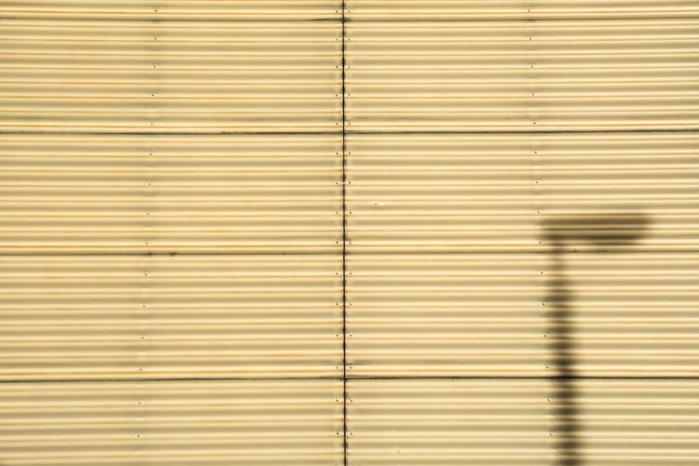 a shadow of a street light on a wall