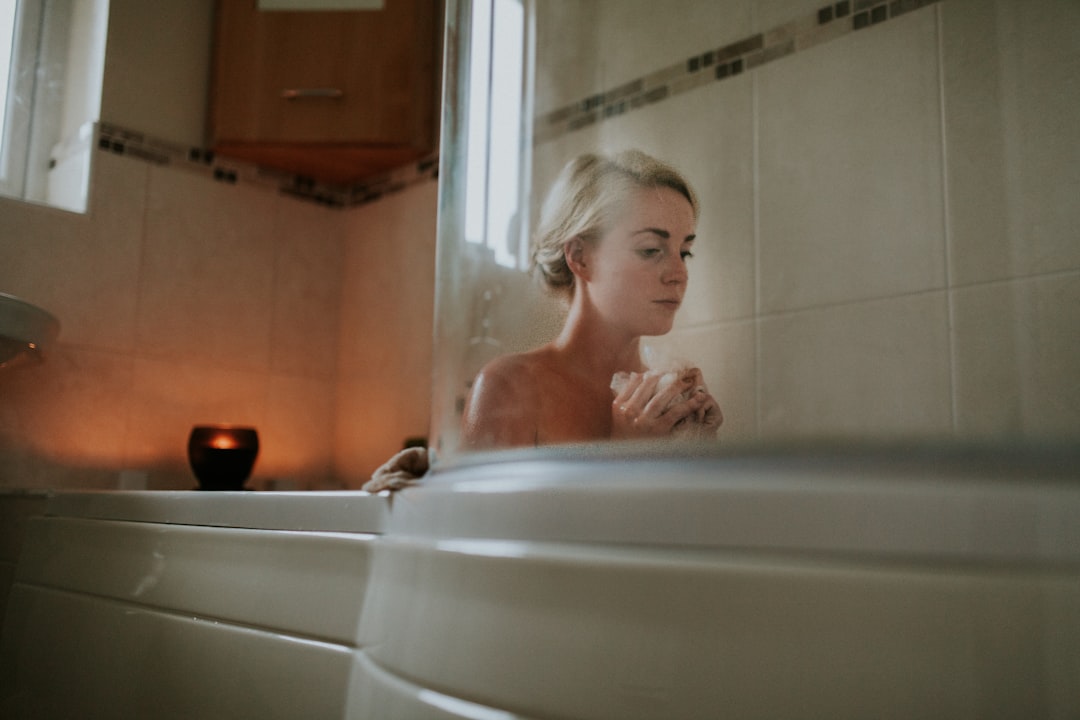 naked woman sitting inside bath tub