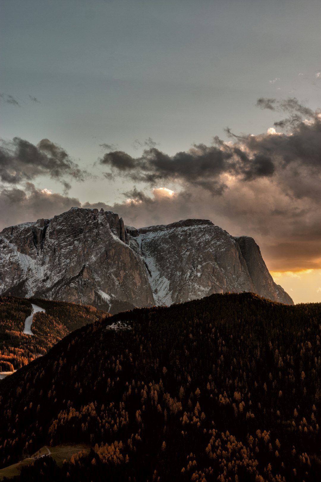 snow covered mountain during sunset