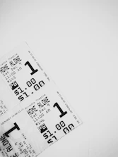 Close-up of a blood-red ticket stub with the movie title embossed.