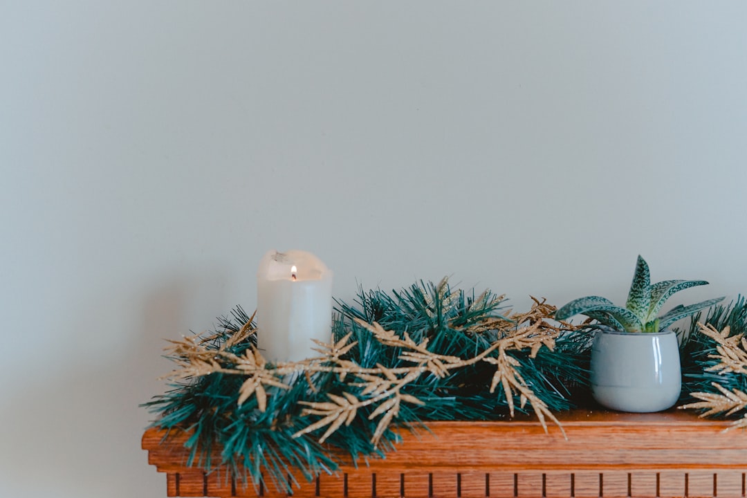 candle with garlands on shelf