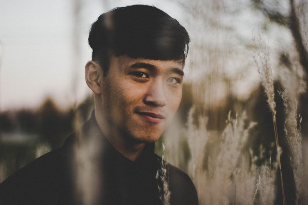 man in black collared shirt