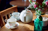 A cozy table setting with bright ceramic plates and a steaming cup of tea.