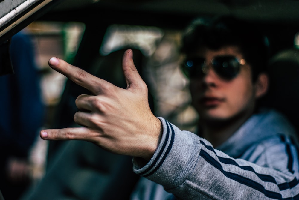 man inside car during daytime