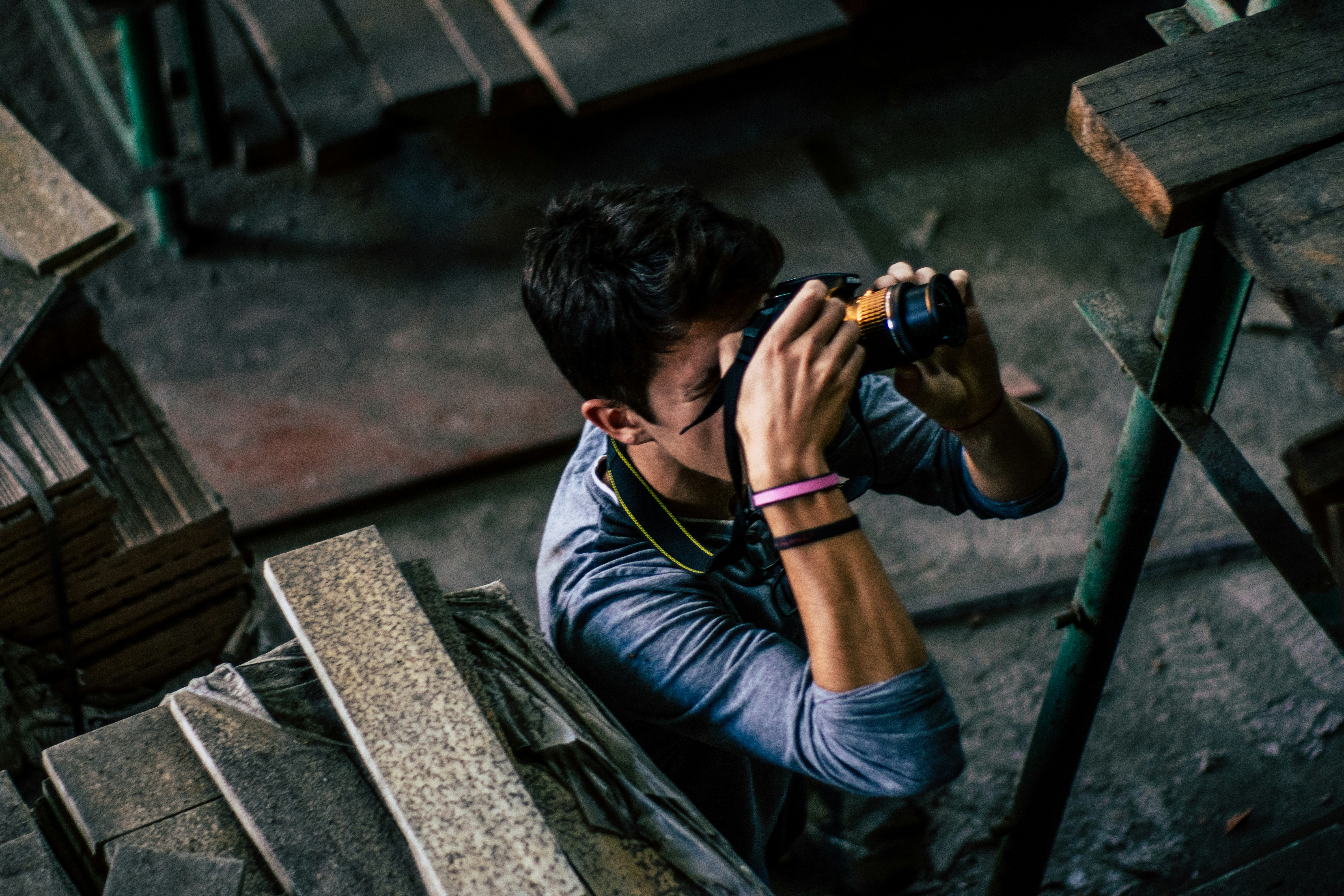 person taking picture surrounded by planks