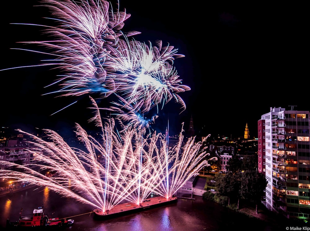 aerial photography of fireworks near buildings at nighttime