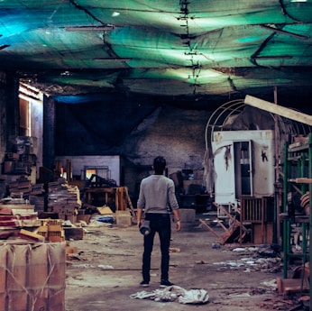 man standing near green steel scaffolding