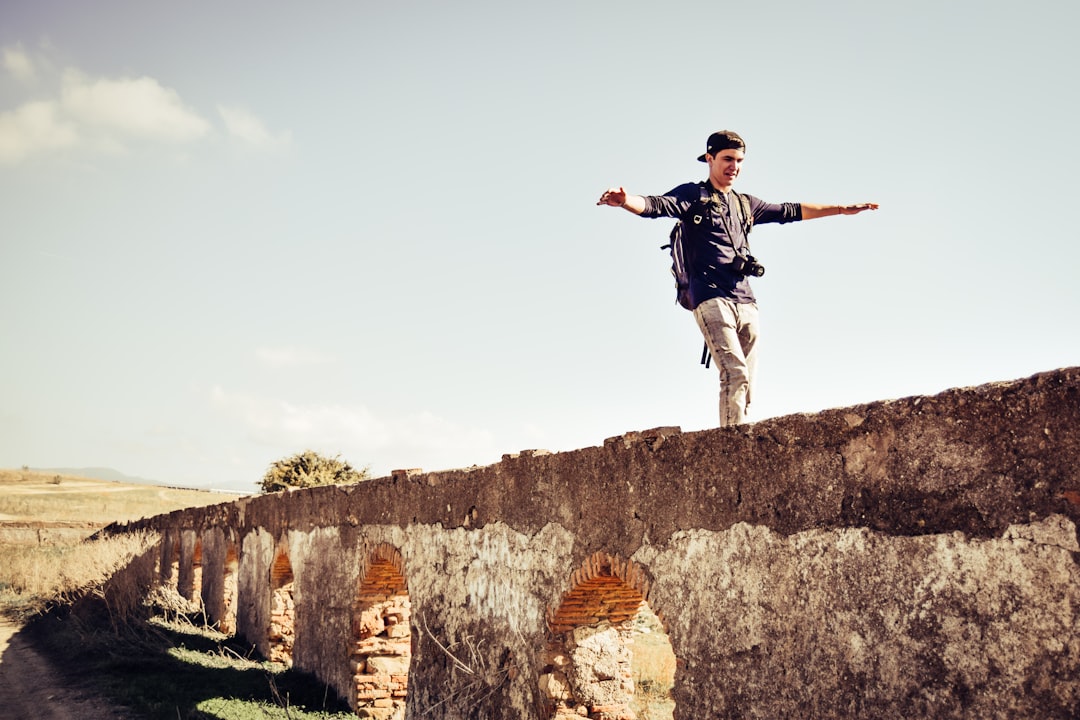 man standing on gray concrete stone during daytime