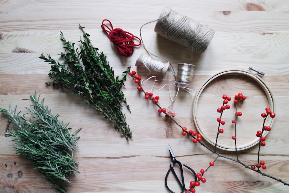 mistletoe placed next to gray and red threads